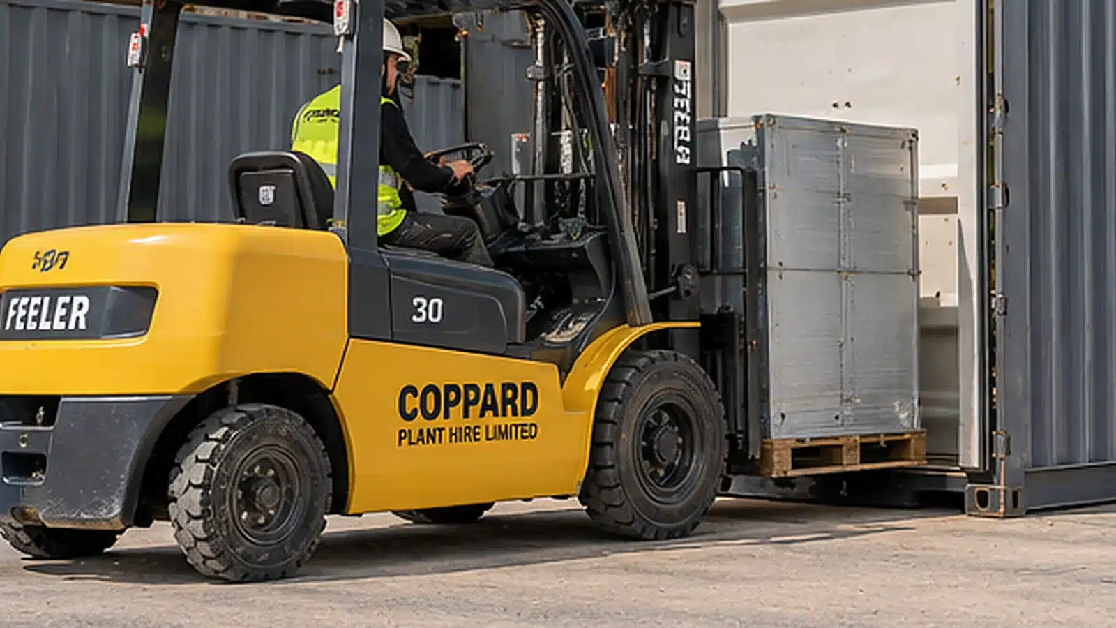 Forklift moving crated materials